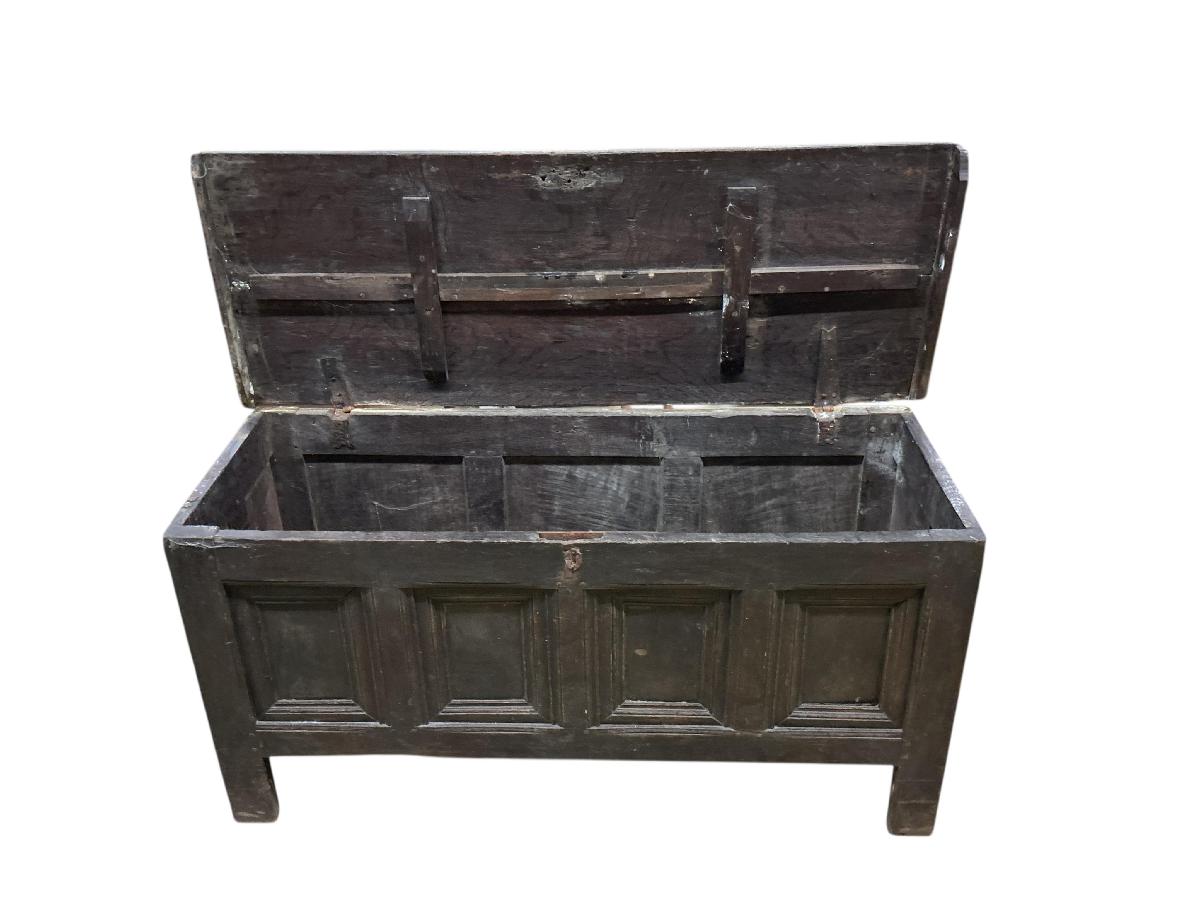 An 18th century panelled oak coffer, width 144cm, depth 54cm, height 72cm